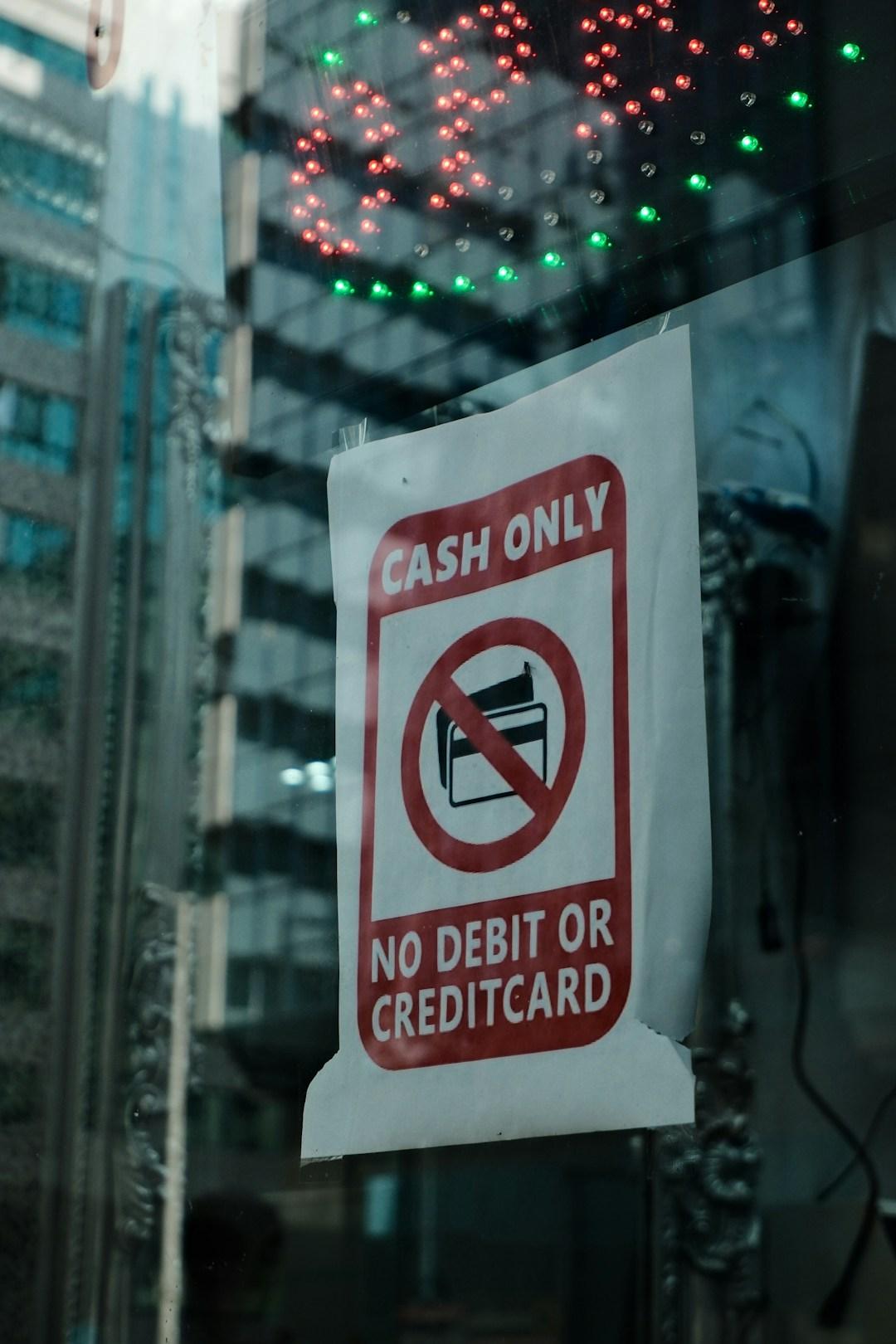 A cash only sign taped up in a shop window after the card machine went down